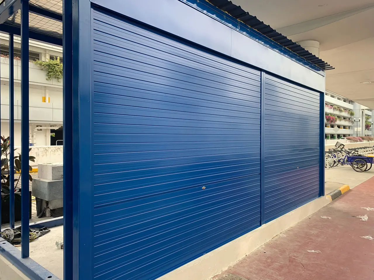 Blue powder-coated aluminium roller shutters installed by Yong Quan