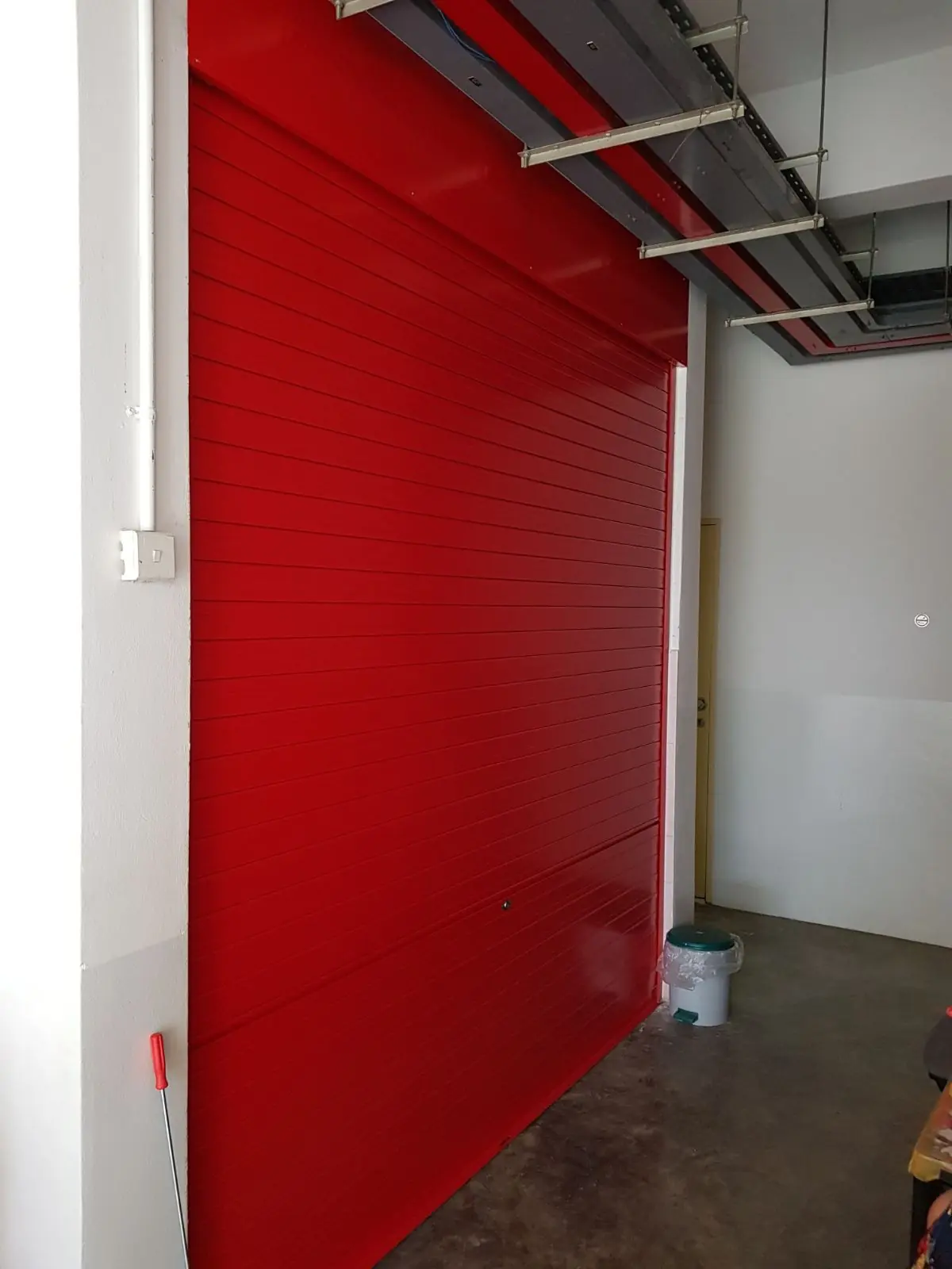 Red powder-coated roller shutter fabricated by Yong Quan