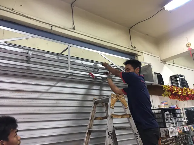 Yong Quan technician installing a roller shutter