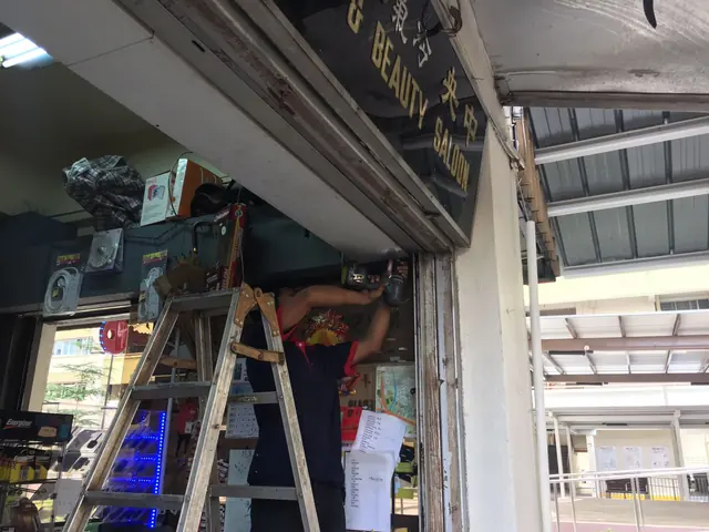 Technician servicing a shop shutter motor
