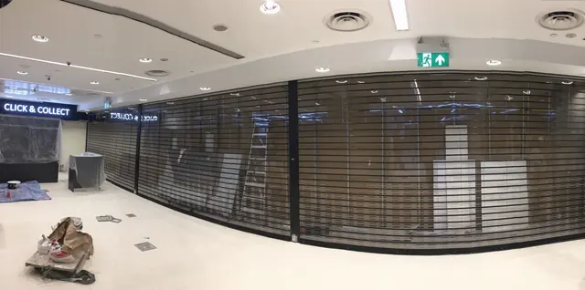 Polycarbonate roller shutters across a mall unit